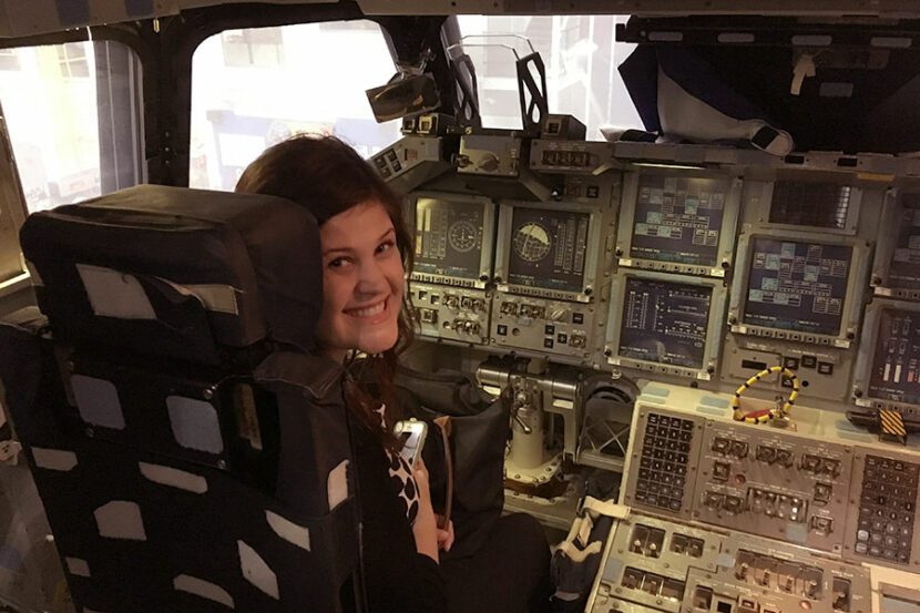 Cassandra Barnes BQMI eemployee in a shuttle mock up